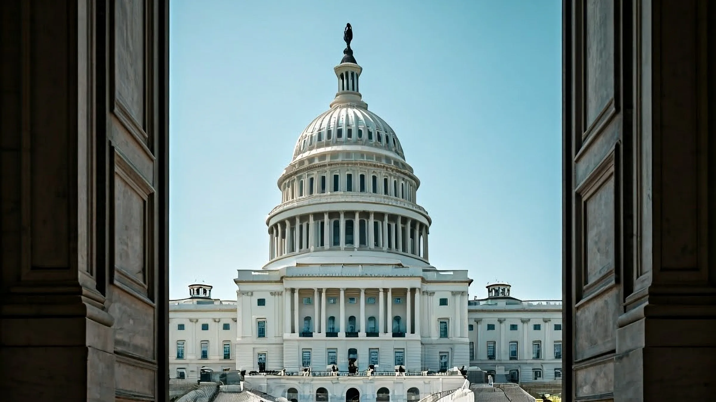 U.S. Capitol building seen through a pair of open doors