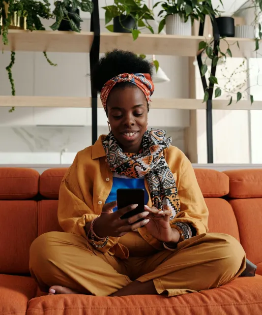 person on couch using phone