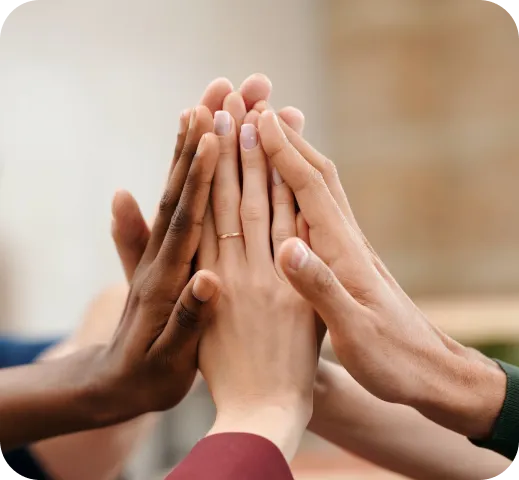 close up of hands doing a group high five