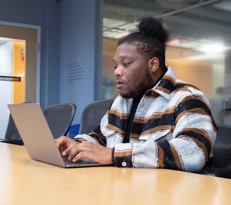 rc alumni using laptop on conference table 