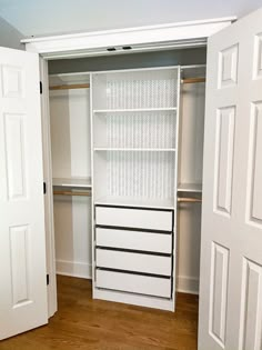 an empty closet with white doors and drawers on the bottom shelf is shown in this image