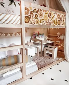 a room with bunk beds, desks and other items in the area that is decorated