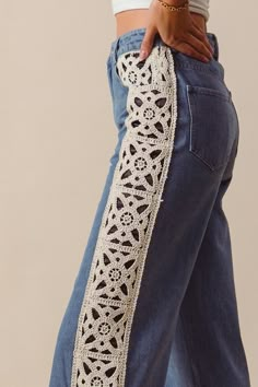 a woman wearing jeans with crochet on the side