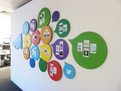 an office wall decorated with colorful circles and cell phones on it's back side