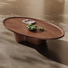 a wooden table with some green apples on it and a magazine sitting on top of it