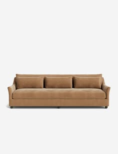 a tan couch with three pillows on it's back and one arm facing the camera