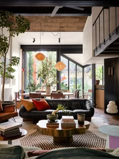 a living room filled with furniture and lots of windows