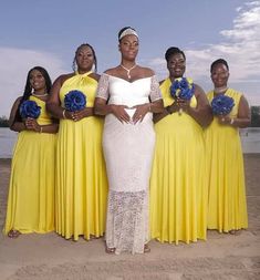 a group of women standing next to each other on a beach