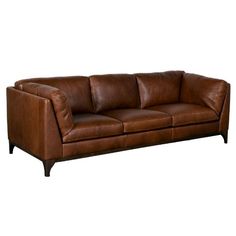 a brown leather couch sitting on top of a white floor