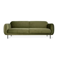 a green couch sitting on top of a white floor next to a black metal frame