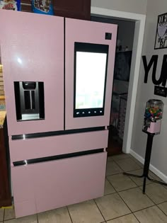 a pink refrigerator freezer sitting inside of a kitchen