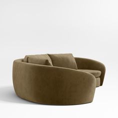 the curved couch is made from suede fabric and has two arms that are connected to each other