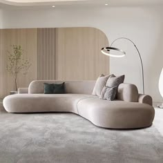 a living room filled with furniture and a large white couch next to a wall mounted lamp