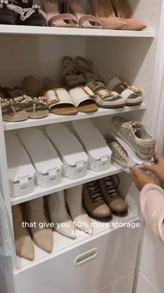 a person standing in front of a white closet filled with lots of shoes and bags