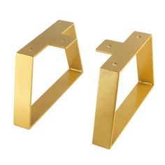 two gold metal brackets on a white background