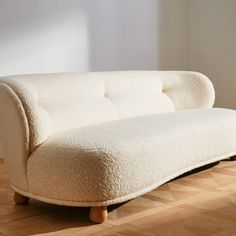 Generously cushioned to hug you as you sit, the Leonne long settee by goop features soft curves for a grand statement on a small scale. The sweeping curved back, tufted buttons and teardrop-shaped American white oak legs certified sustainable by the Forest Stewardship Council r FSC come together for a piece that is elevated and timeless. Designed for small spaces, the sophisticated settee is also perfect for creating intimate seating in larger rooms. CB2 exclusive.  -Designed by goop -FSCr-certi Apartment From Outside, Navy Velvet Chair, Sofa For Bedroom, White Wood Furniture, Christmas Burgundy, Homey House, Burgundy Christmas, Shea Homes, Mini Sofa