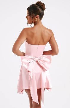 The Freja mini dress is party perfection. Crafted in luxurious stretch satin, this beautiful design is strapless with a corseted bodice and flirty, flouncy skirt. A dramatic bow to the back finishes the look. 



Colour: Blush.

Luxury stretch satin.

Oversized bow to back.

Strapless.

Corset body.

Zip fastening to reverse.

Mini length.

Model is an XS and is wearing an XS.

 Size: XS, S, M, L, XL, XXL Homecoming Dresses Corset, Cute Formal Dresses, Cute Homecoming Dresses, Hoco Dress, Maxi Dress Sale, Strapless Corset, Winter Formal, Blush Dresses, Sparkle Dress