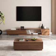 a living room with a large flat screen tv mounted on the wall next to a coffee table