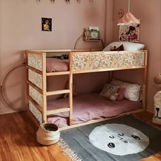 a wooden bunk bed sitting on top of a hard wood floor next to a rug