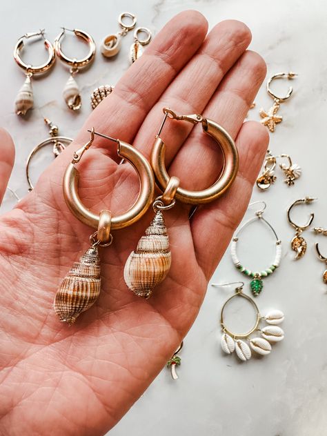 Bring the beach wherever you go with our Seaside Summer Earring Collection. This golden assortment features hoops with delicate sea creatures charms, including starfish and sea horses, and dangles with shells and gold edged shells. Perfect for adding a touch of the ocean to any outfit! Sea Horses, Earring Collection, Summer Earring, Earrings Collection, Sea Creatures, Starfish, The Ocean, Shells, The Beach