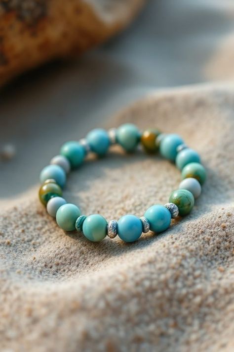 Turquoise beaded bracelet on sandy beach surface. Bead Bracelet Ideas Aesthetic, Clay Bead Bracelet Ideas Aesthetic, Bracelet Ideas Aesthetic, Make Your Own Clay, Clay Bead Bracelet Ideas, Bead Bracelet Ideas, Clay Bead Bracelet, Trendy Bracelets, Monochrome Design