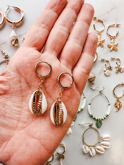 Bring the beach wherever you go with our Seaside Summer Earring Collection. This golden assortment features hoops with delicate sea creatures charms, including starfish and sea horses, and dangles with shells and gold edged shells. Perfect for adding a touch of the ocean to any outfit! Sea Horses, Earring Collection, Summer Earring, Earrings Collection, Sea Creatures, Starfish, The Ocean, Shells, The Beach