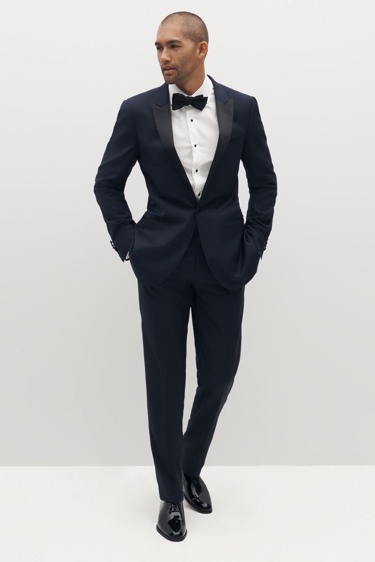 Limited Edition Style: We’ve reached the pinnacle of style with the peak lapel tuxedo, Italian-made and crafted from 100% merino wool. Sleek black, clean design, and an updated lapel come together to bring modern flair to the traditional tuxedo. Satin detailing on the lapel, waistband, and pant seam complete the look. Dark Navy Blue Suit Men, Tuxedo Peak Lapel, Tuxedo Women Suits, Navy Blue Suit Men, Dark Navy Blue Suit, Traditional Tuxedo, Peak Lapel Tuxedo, Navy Tuxedos, Women Suits Wedding