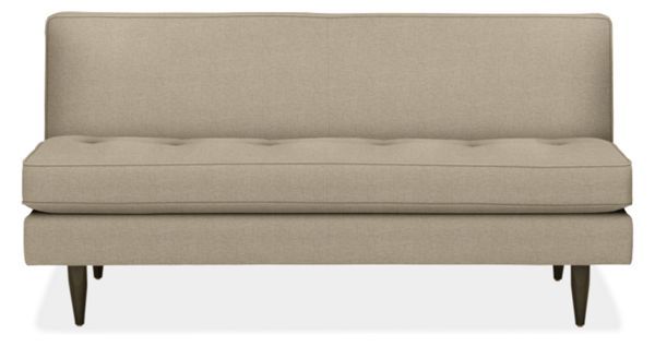 a beige couch sitting on top of a white floor