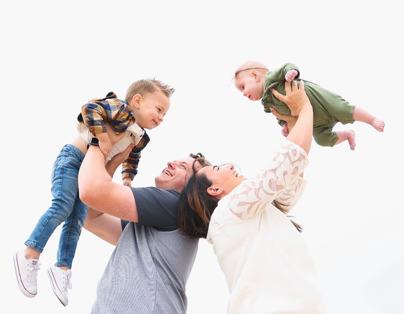 Photo of Tanner Linsley and his wife playing with their kids.