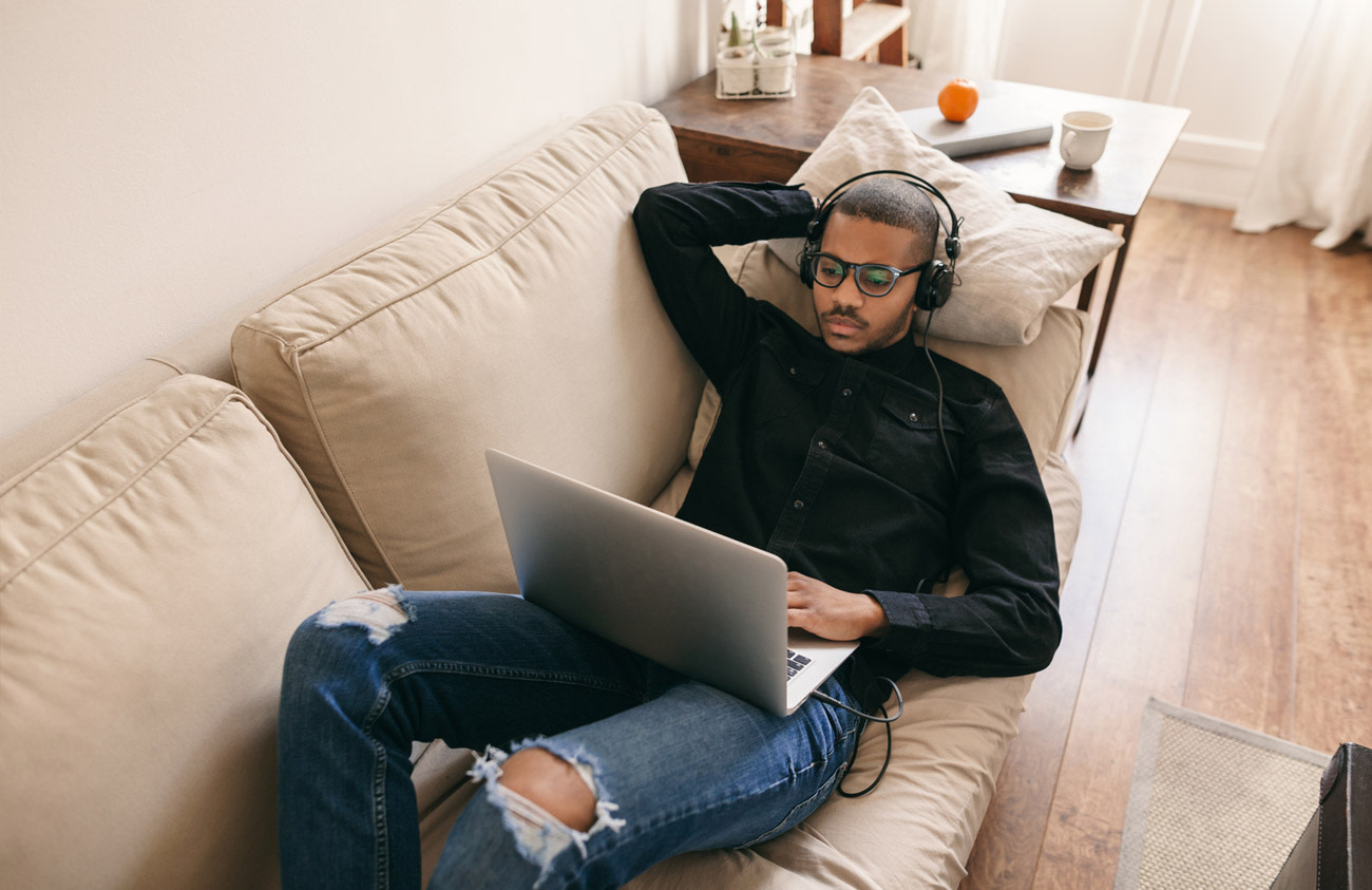 Man on sofa with laptop