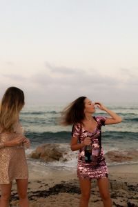 Kaboompics - Muted Tones & Golden Hour Hues - Women Celebrating by the Sea with Champagne