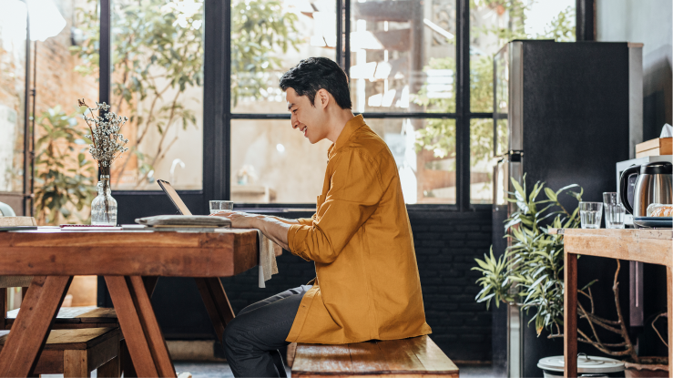 Person sitting at a desk, working on a laptop 