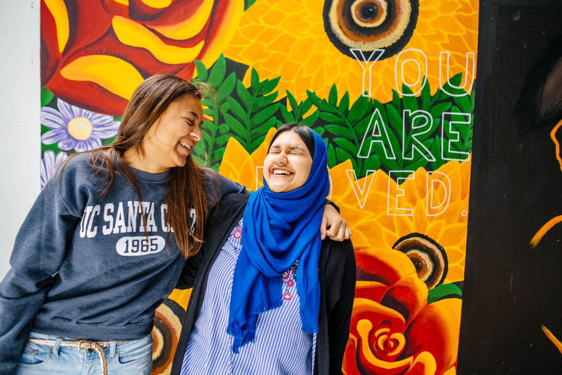 Two students smiling and laughing