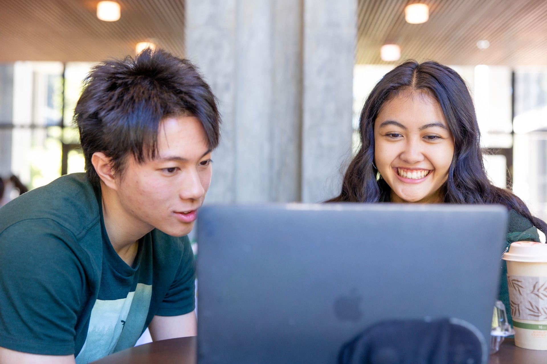 Two students looking at a computer