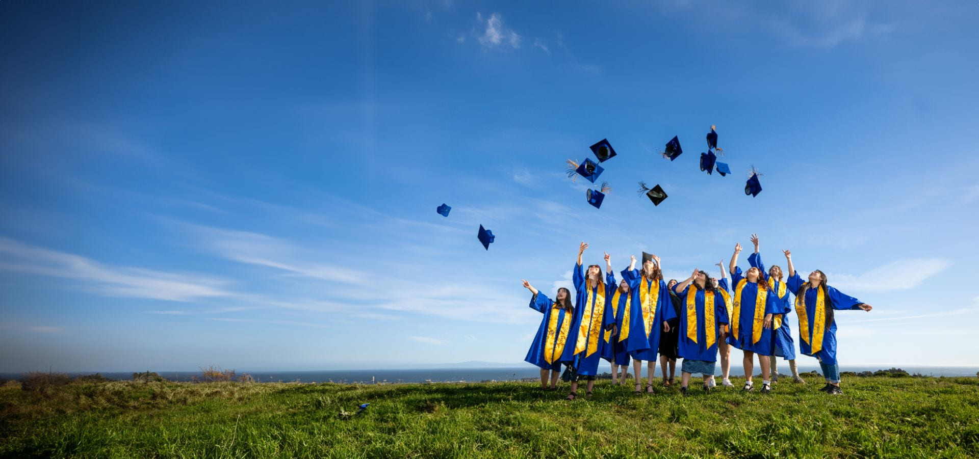 Students throwing their graduation caps in the air