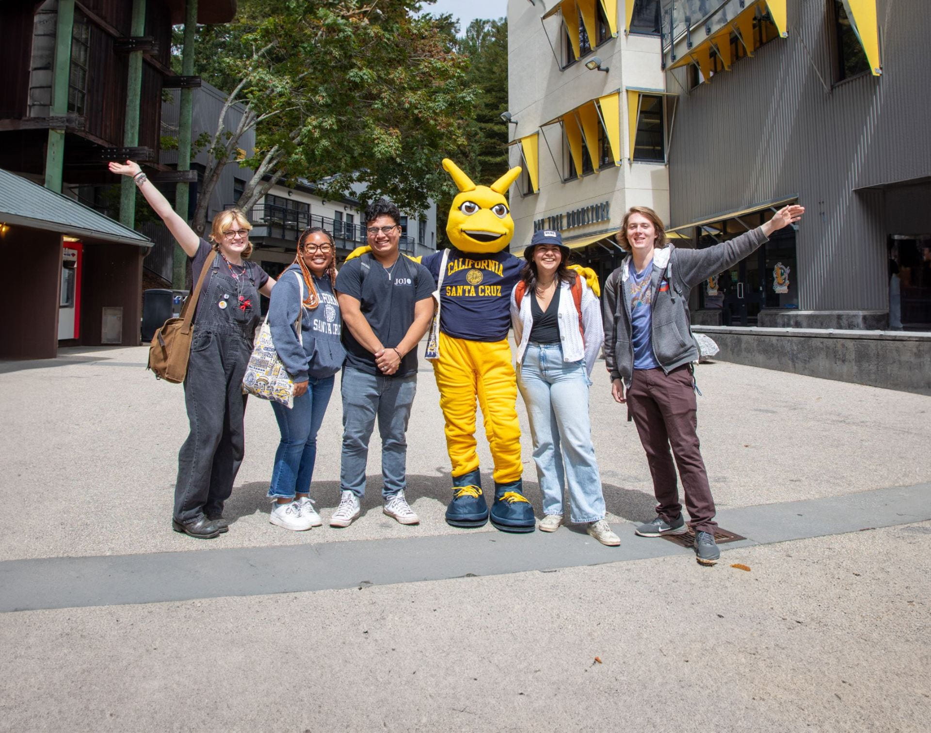 Sammy Slug standing next to students in Quarry Plaza