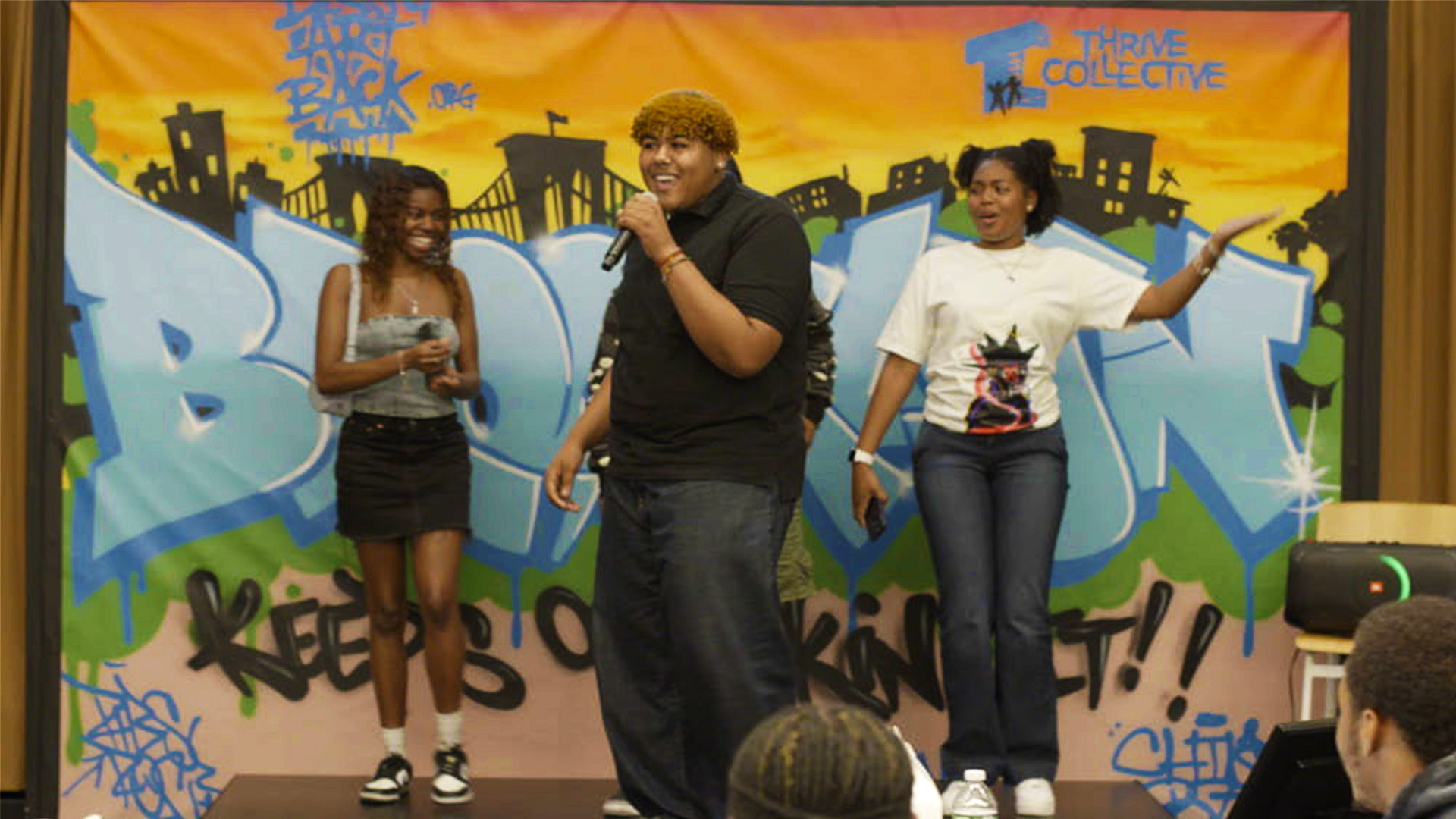 A group of people standing on a stage.