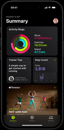 Summary tab screen in the Fitness app showing Activity rings, Trainer Tips, Step Count and recommended Fitness+ workouts on iPhone