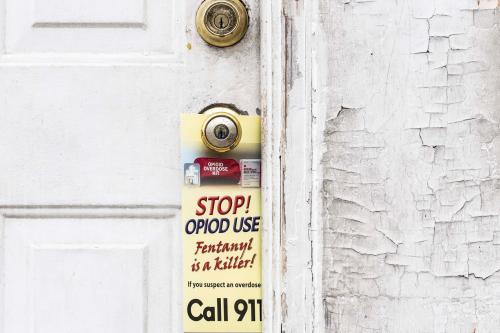 A stop opioids use door knocker hangs on a doorknob during an opioids outreach event along W. 23rd and N. Market streets in Wilmington, Wednesday, Dec. 6, 2023.