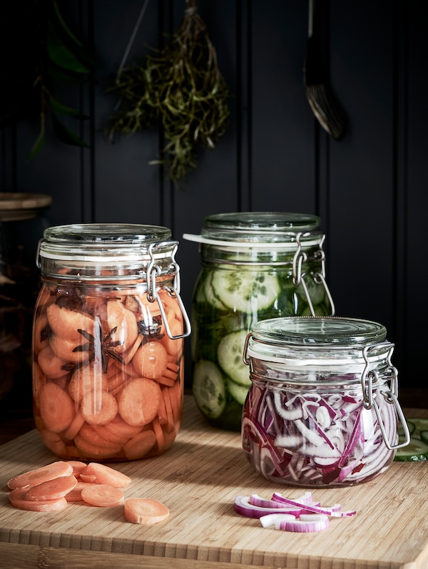 KORKEN jars with onions, cucumbers and carrots in them