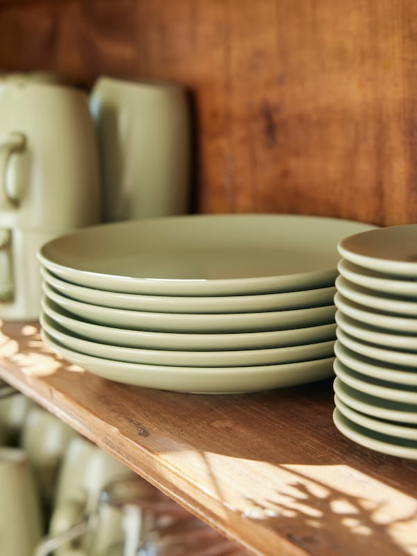 White FÄRGKLAR bowls, plates and wine glasses on a table