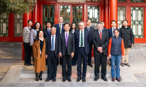 Delegates stand for a photograph at Tsinghua University.