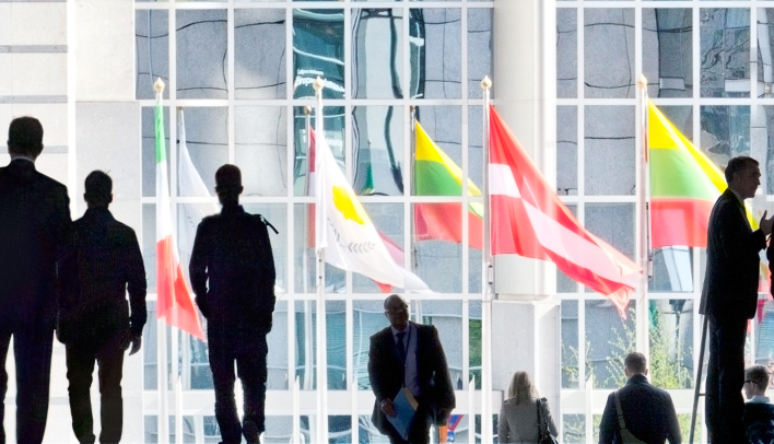 People in front of flags